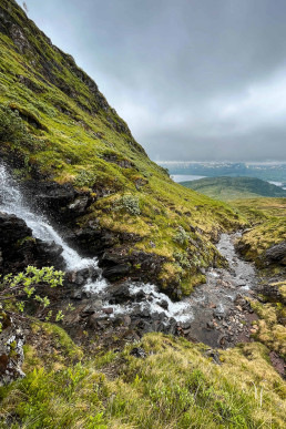 a waterfall on a rocky hill