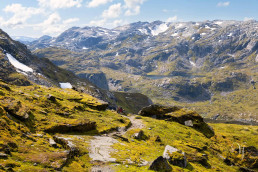 a mountain landscape with a person on a path