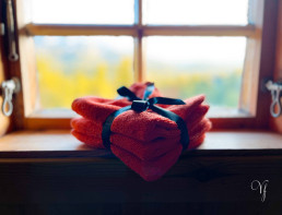 a stack of towels tied with a black ribbon